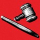 A broken gavel on a red background