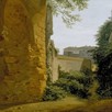 A painting of a town with a crumbling wall and green plants climbing up a building