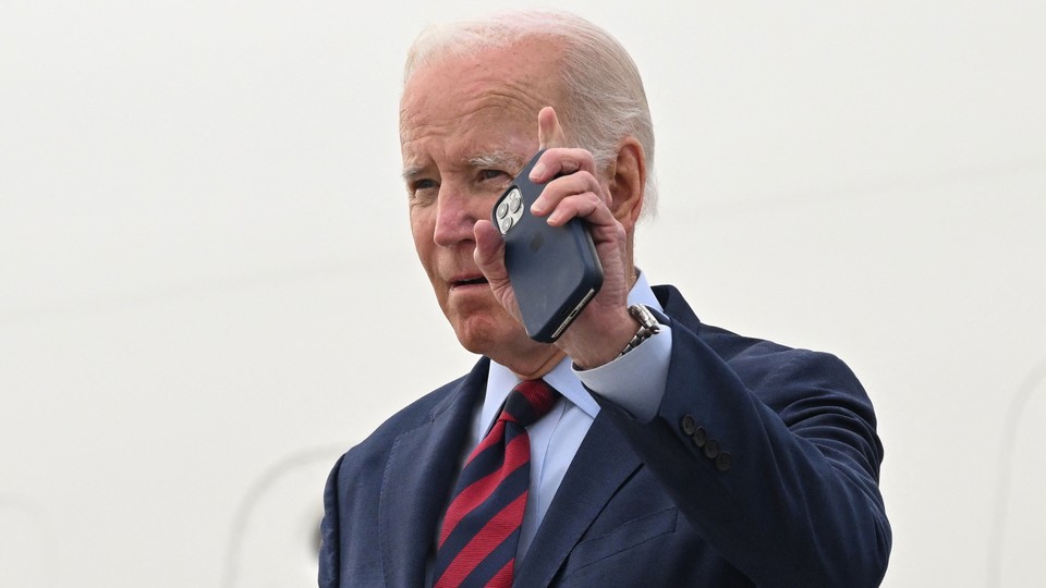 Joe Biden holding an iPhone