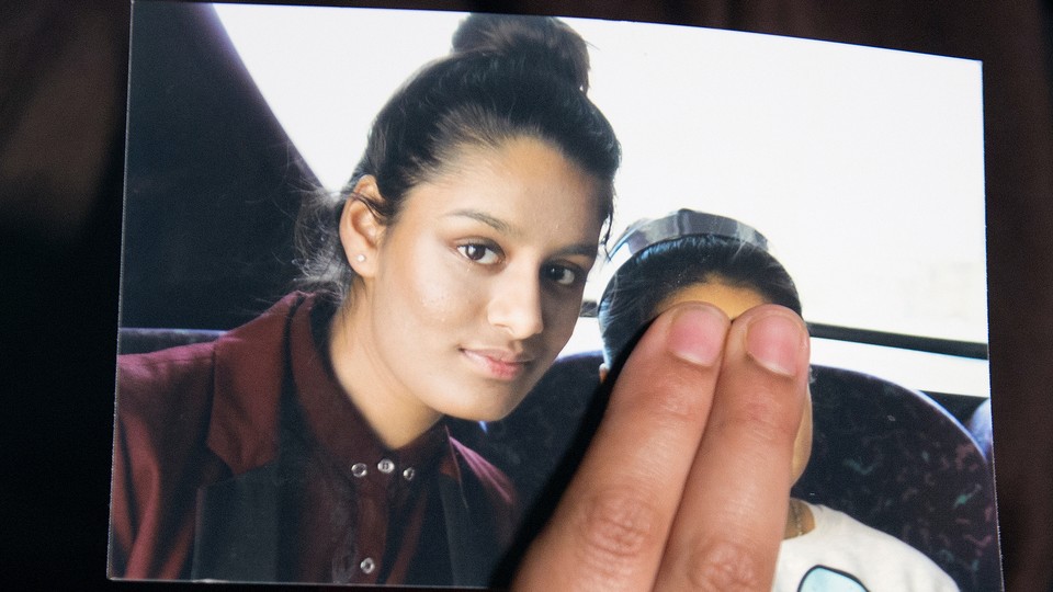 Renu Begum, the sister of Shamima Begum, holds a photo of her sister.