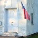 Photograph of a church entrance with an American flag hanging on it
