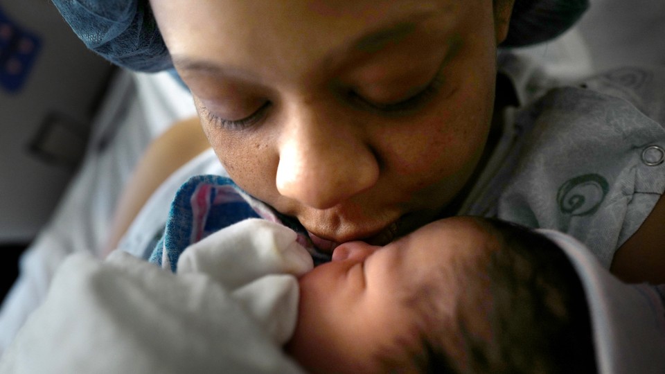 Maya Warren, 31, holds her newborn baby Kortez Isaiah Wallace at Providence Hospital in Washington, D.C., on Friday, December 2, 2016. The first time mother works as an Uber driver with no paid time off for maternity leave.