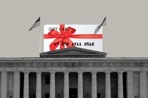 A giant gift card on top of a building