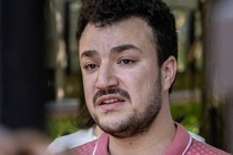 A color photo of Mahmoud Khalil, wearing a pink patterned polo shirt.