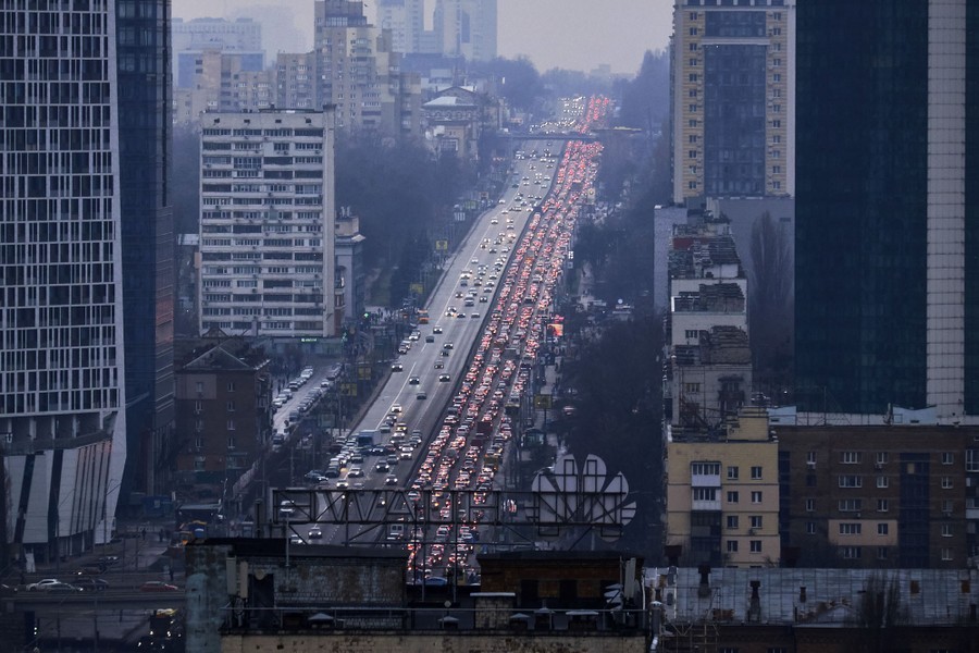 Long lines of cars are seen on a broad city street.