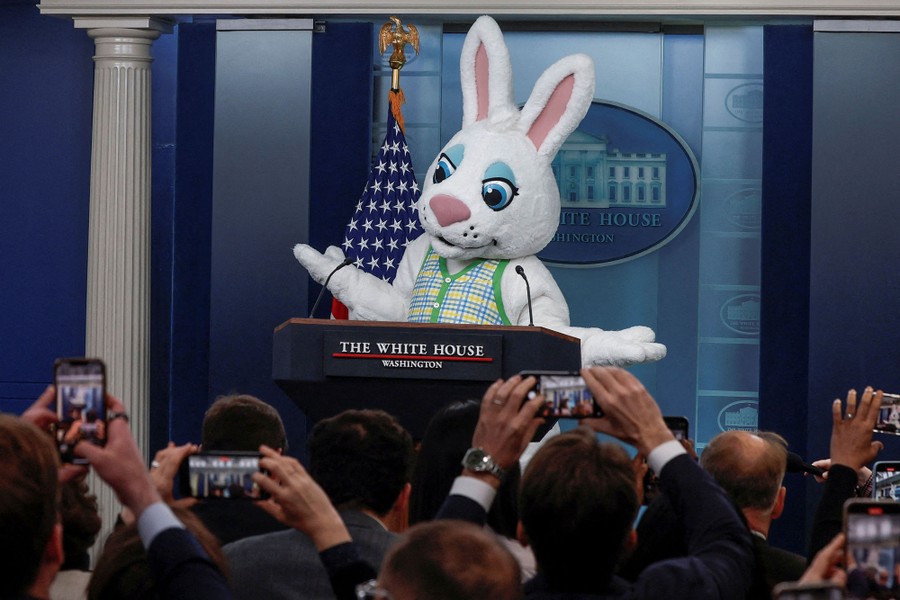 A person wearing an Easter Bunny costume stands at a lectern labeled "The White House, Washington."