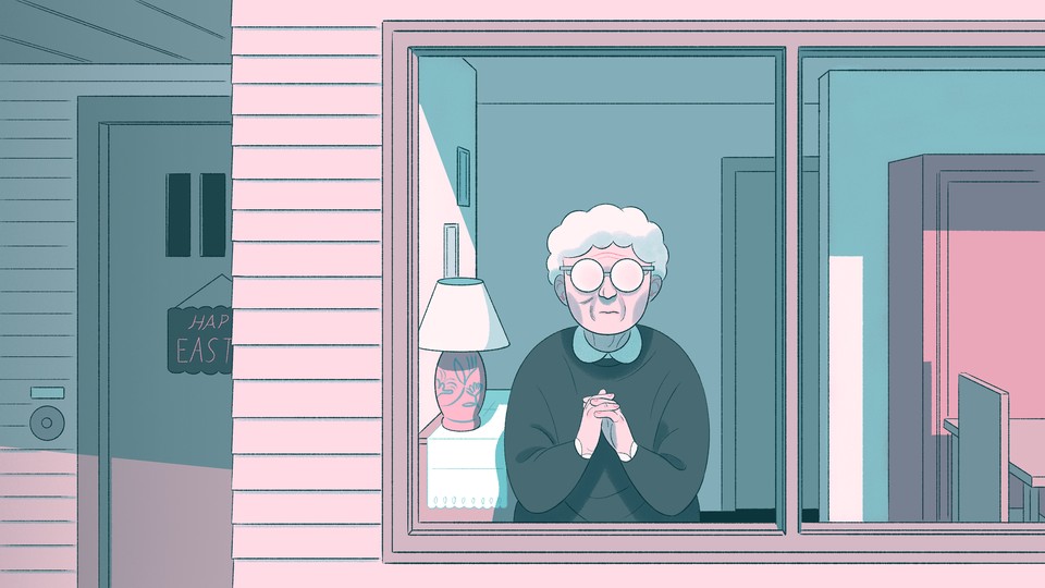 An elderly woman looks out a window