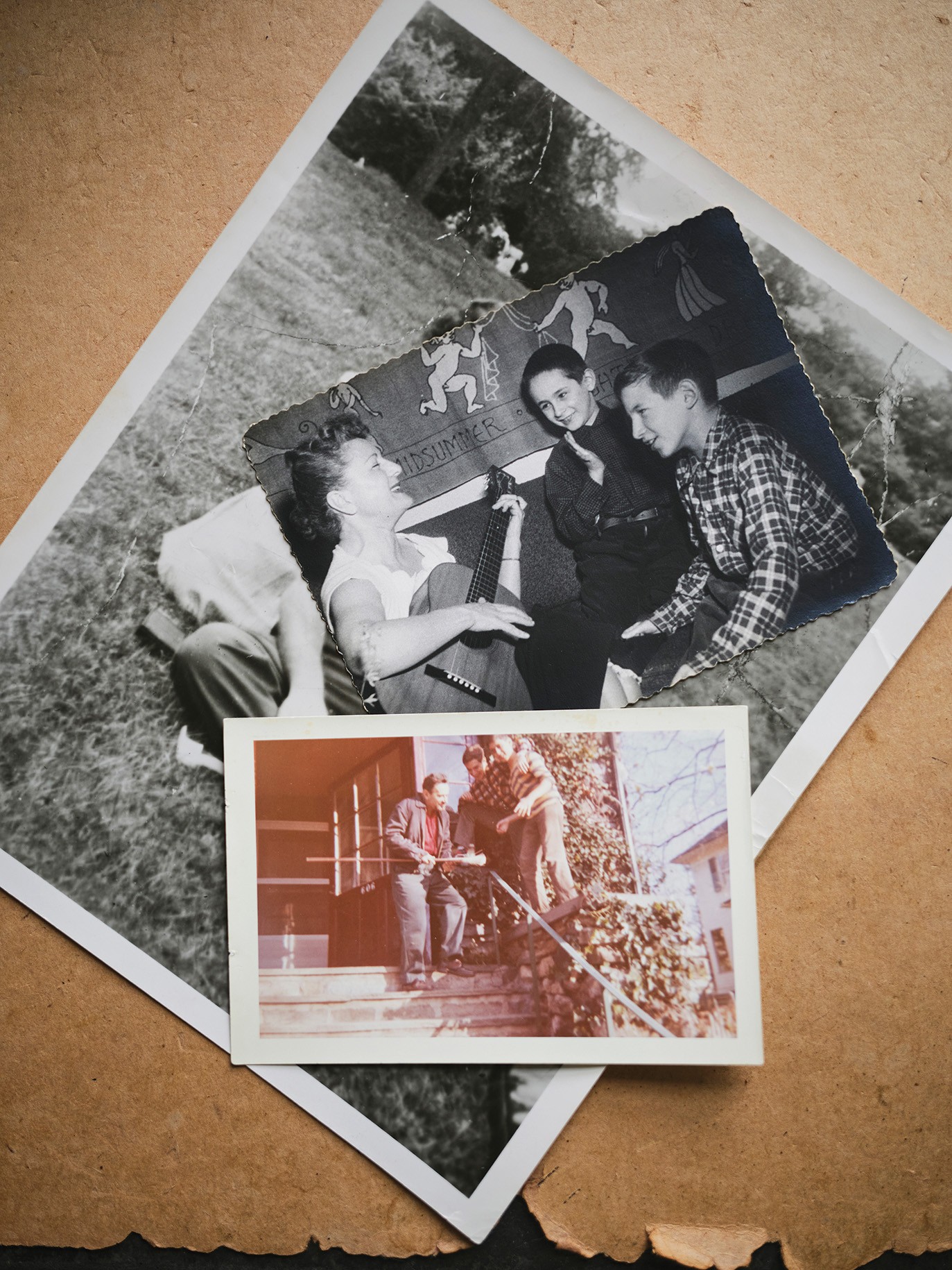 color photo of several stacked childhood photos of family scenes, outdoors, and a woman playing guitar to two boys