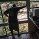 A volunteer looks out over the Guadalupe River while helping clean a resident's home in Hunt, Texas.