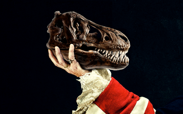 dinosaur skull held up by an arm