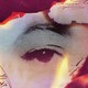 scraps of burning paper surrounding an eye