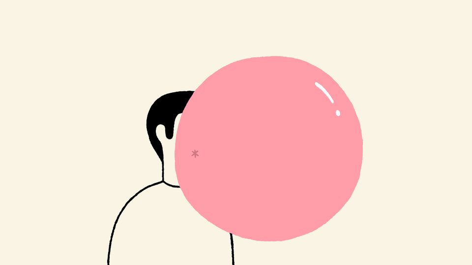 A man blowing a big chewing-gum bubble.