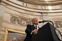 Donald Trump stands at a podium to speak