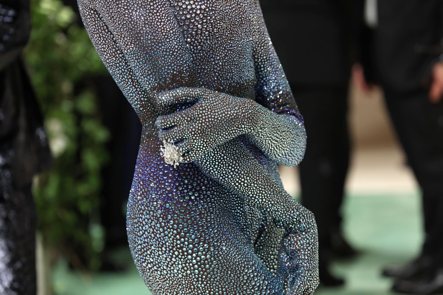 A close view of a person wearing a shimmering full-body garment