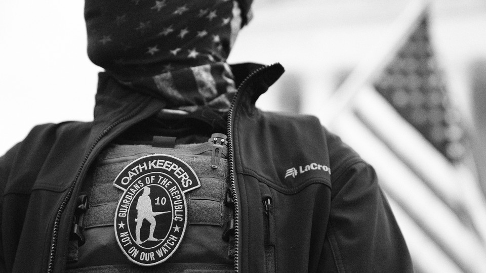 A person with an Oathkeepers patch.