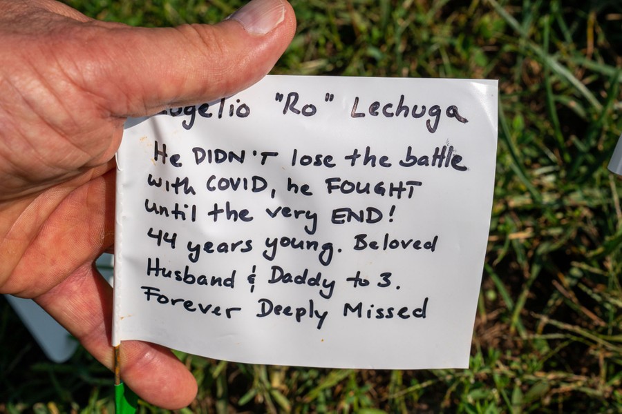 A personal message is written on a flag, addressed to a "Beloved husband & Daddy to 3."