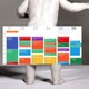 Black and white photo of a baby with a calendar covered in colored blocks superimposed