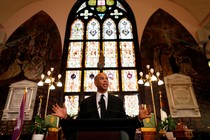 Cory Booker stands in front of a church tabernacle while speaking at the Mother Emanuel church in South Carolina.