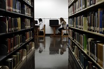 Students sit in a library.