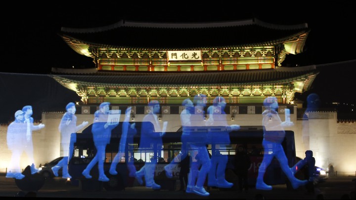 Holograms of protesters are shown in front of Gyeongbok Palace in South Korea