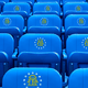 An illustration of sporting seats decorated with the Georgia state seal