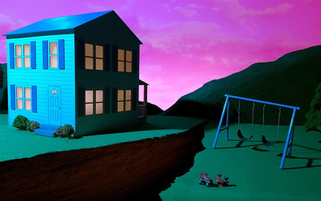 A house and a front yard, with a gigantic crack between them