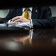 Donald Trump's hands rest on a stack of papers while he sits in court for his criminal trial