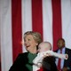 Hillary Clinton holds a baby after attending a campaign rally in Charlotte, North Carolina on October 23, 2016.