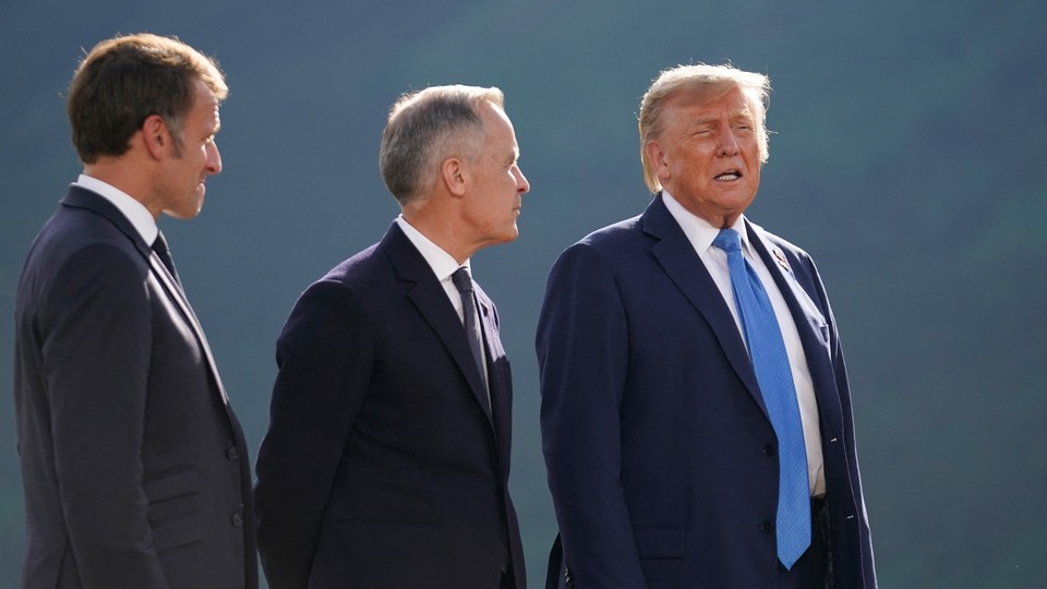 Emmanuel Macron, Mark Carney and Donald Trump pose for a family photo during the Group of Seven (G7) Summit on June 16, 2025