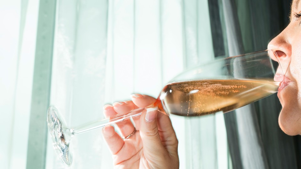 An image of a woman drinking a glass of champagne.