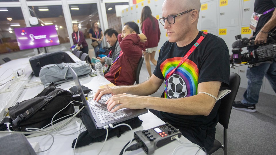 Grant Wahl works on a story from the FIFA Media Center before a November 21 match