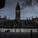 A man walks in front of Manche​ster Town Hall in the deserted​ center of Manchester after Prime Minister Boris Johnson​ imposed a lockdown on England.