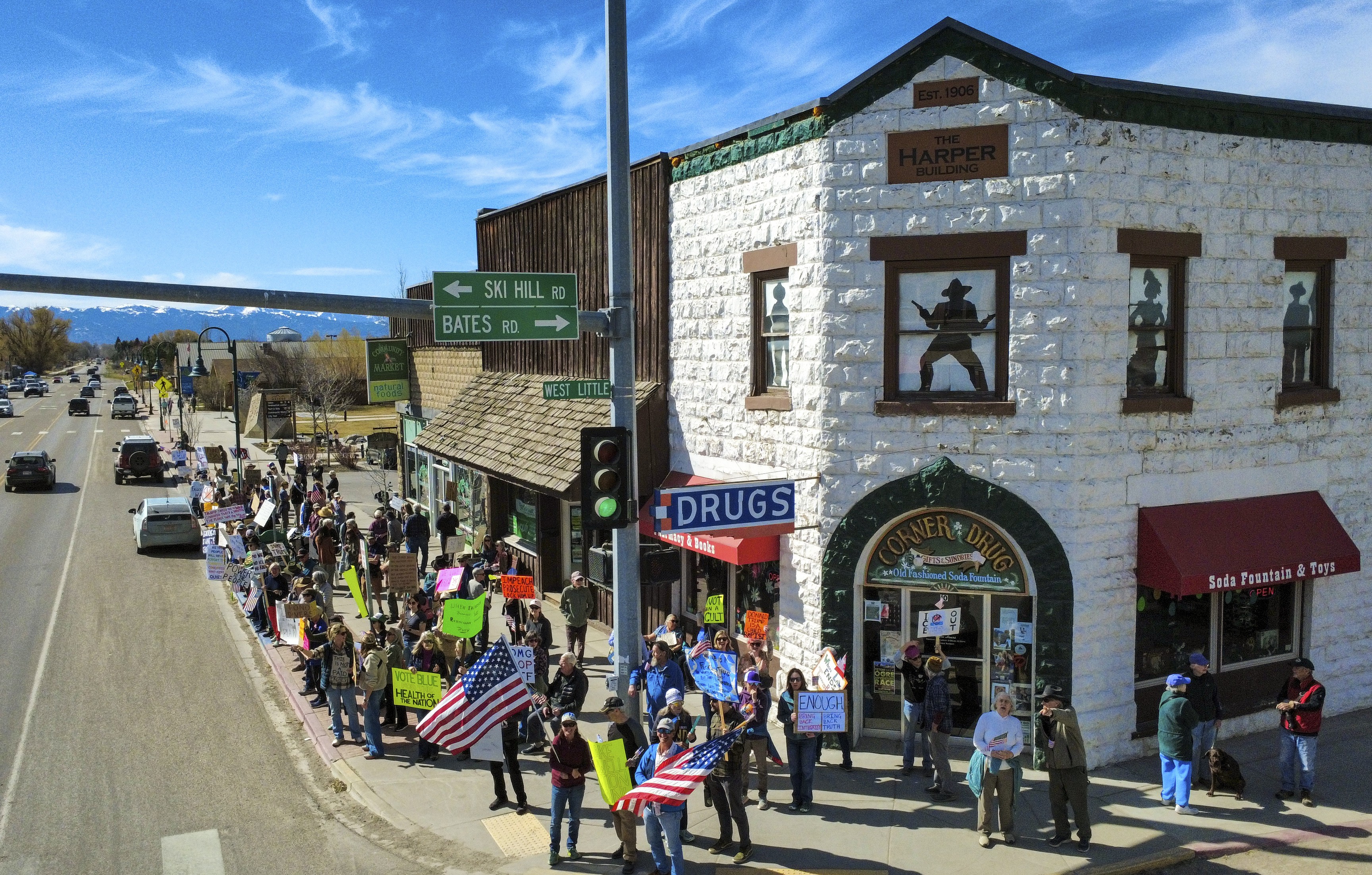 Protesters gather on a street corner in a small Idaho town.