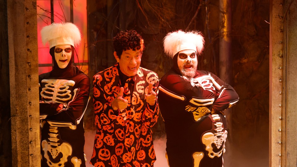 Tom Hanks as David S. Pumpkins, with two dancing skeletons, on 'SNL'