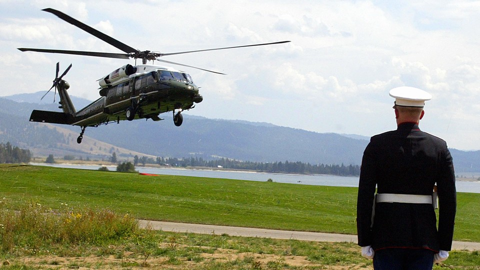 A US Marine honor guardsman stands at attention as Marine One lands with US President George W. Bush