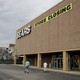 Two people walking into a Sears store that is slated to close
