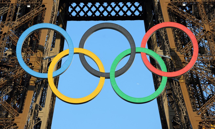 The Olympic rings hang from the side of the Eiffel Tower.