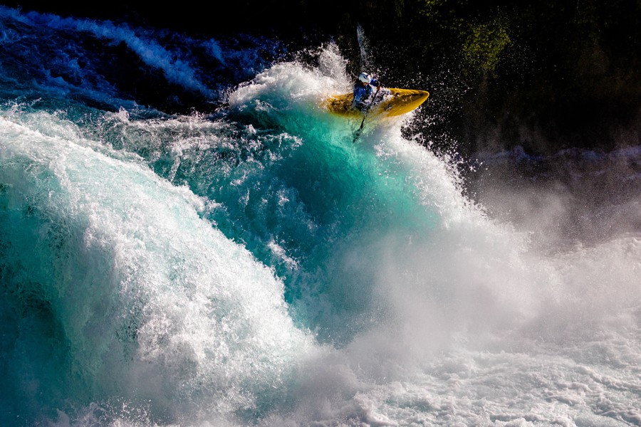 A kayaker rides through an energetic waterfall.