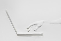 An illustration of a white hand in front of a laptop