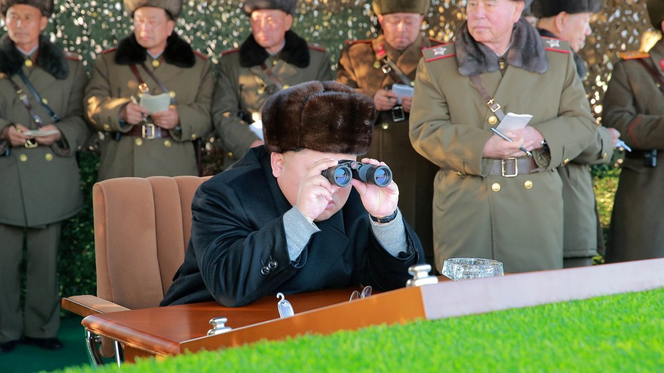 North Korean leader Kim Jong Un guides a firing contest among multiple launch rocket system batteries.