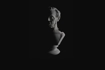 photo of cracked bust of Lincoln on black background