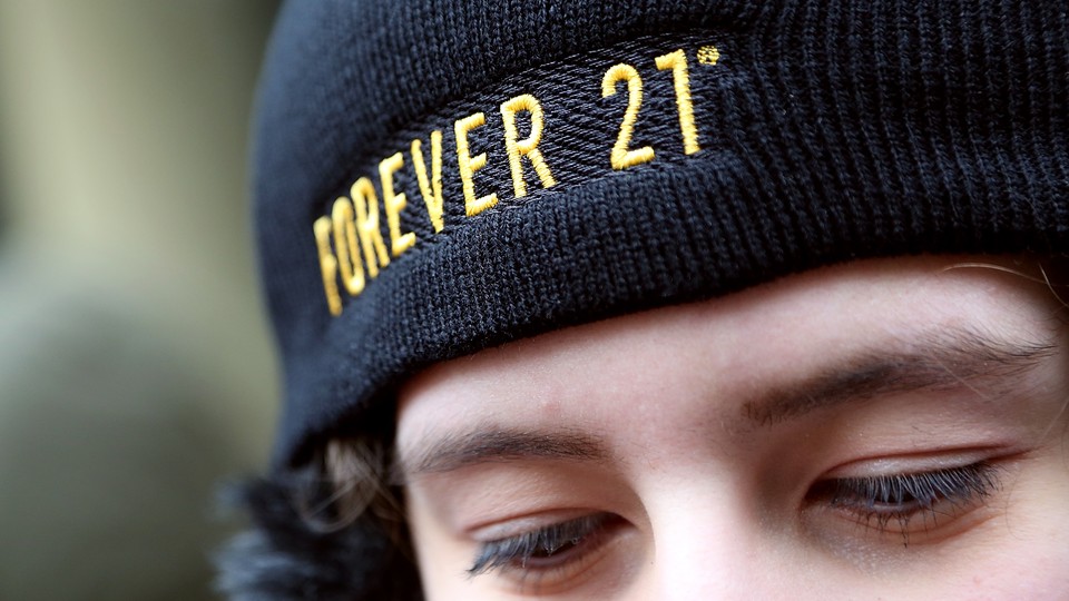A person wearing a black Forever 21 hat