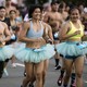 A group of runners wearing light-blue running tutus