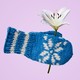 An illustration of a mitten with a flower tucked into it