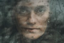 Photo of Evgenia Kara-Murza staring into the camera from behind slightly opaque glass