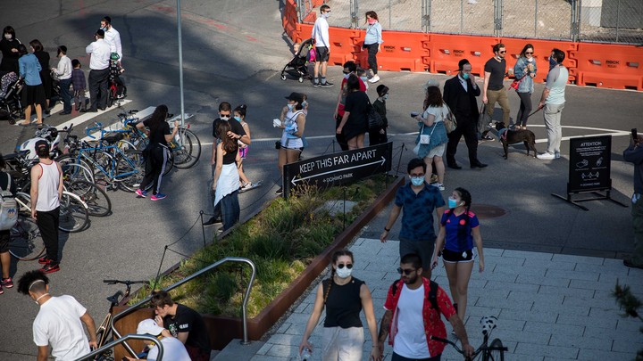 People walk in Domino Park during the coronavirus pandemic in Brooklyn