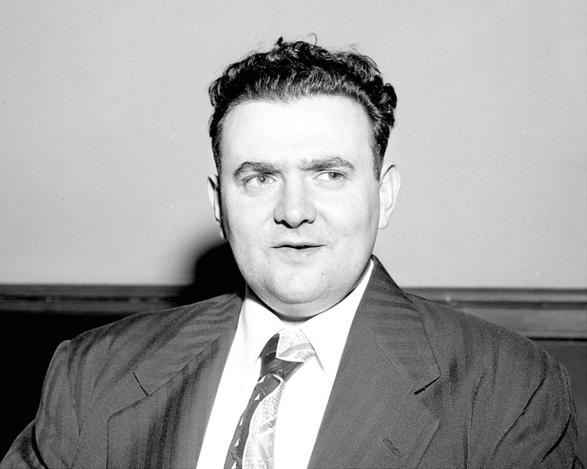 black-and-white archival photo of man in suit and tie