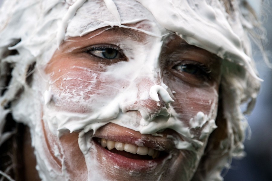 A close view of a person's face, covered in soapy foam.