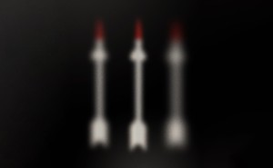 Illustration of three out-of-focus fuzzy red-tipped white arrows on black background