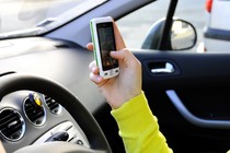 A driver uses a smartphone app in a car